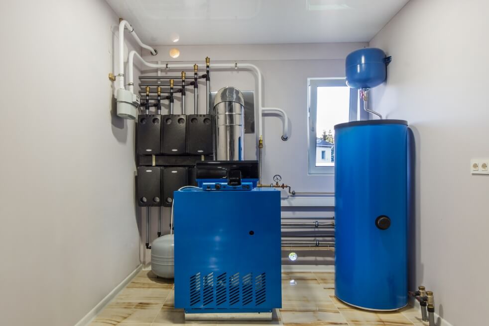 a boiler room with a blue water heater and furnace