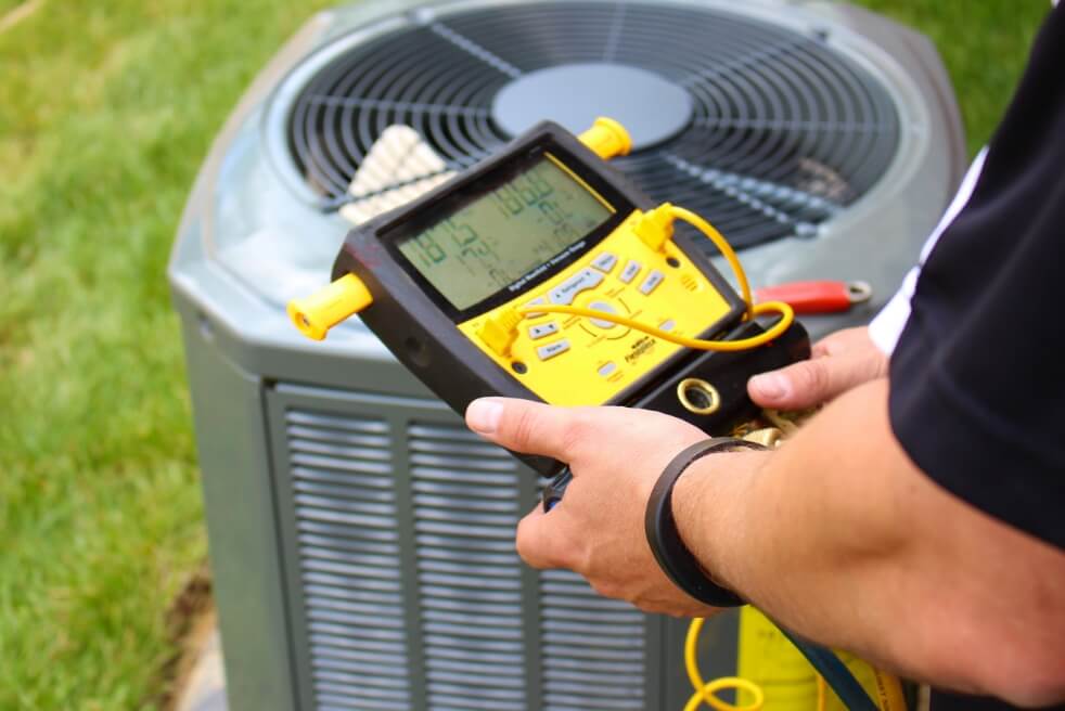 a device is hooked up to an AC unit taking measurements