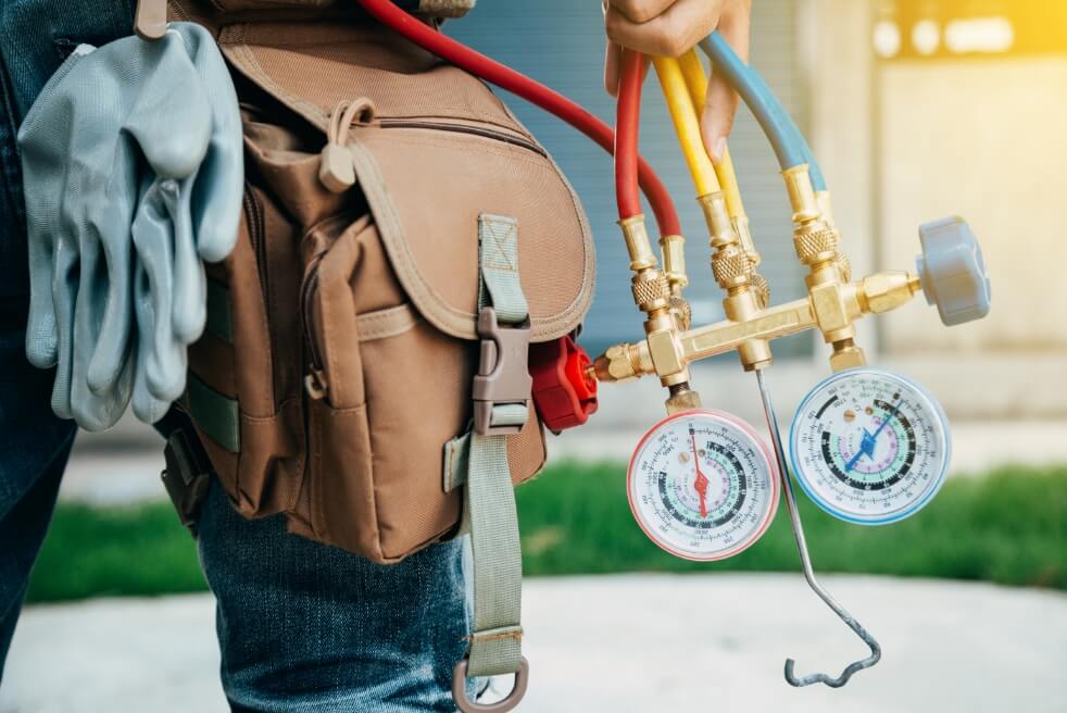 an hvac tech wearing a utility belt of tools