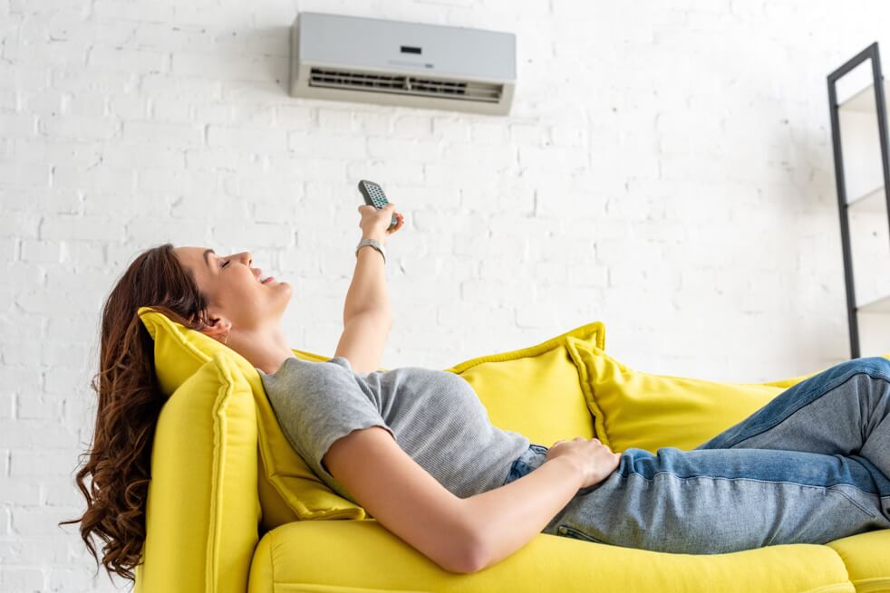woman staying cool with her air conditioner
