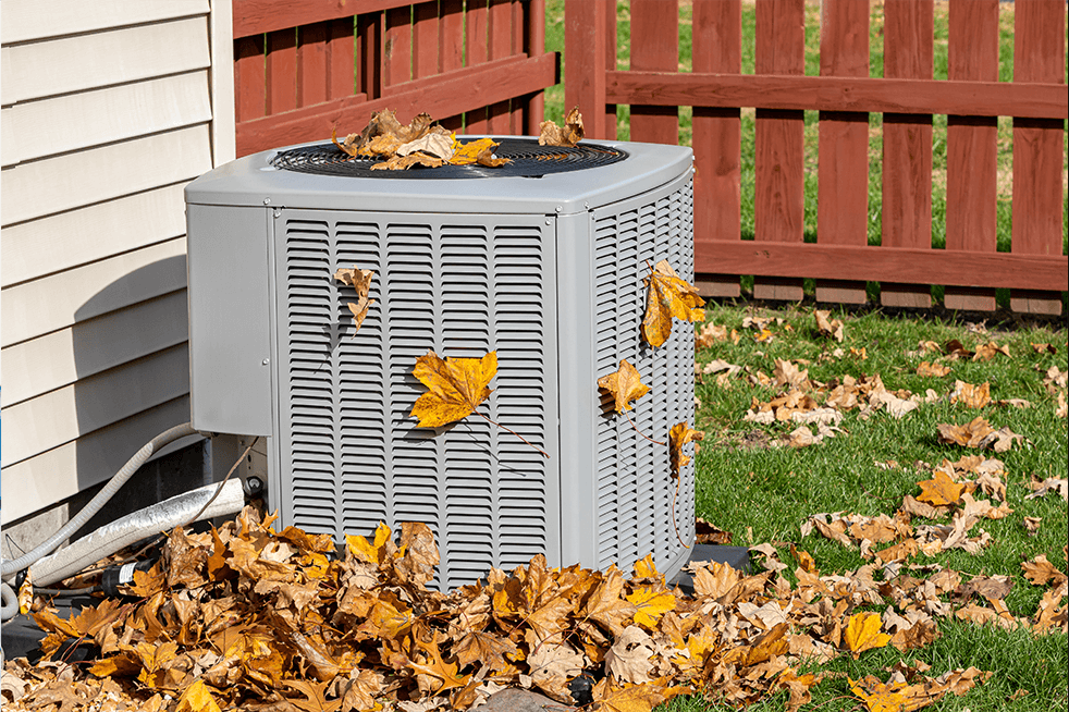 Dirty air conditioning unit covered in leaves during autumn. Home air conditioning, HVAC, repair, service, fall cleaning, good deal on maintenance