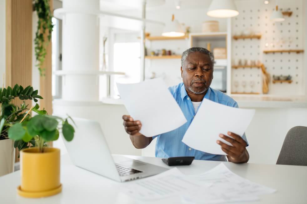 man looking at bills