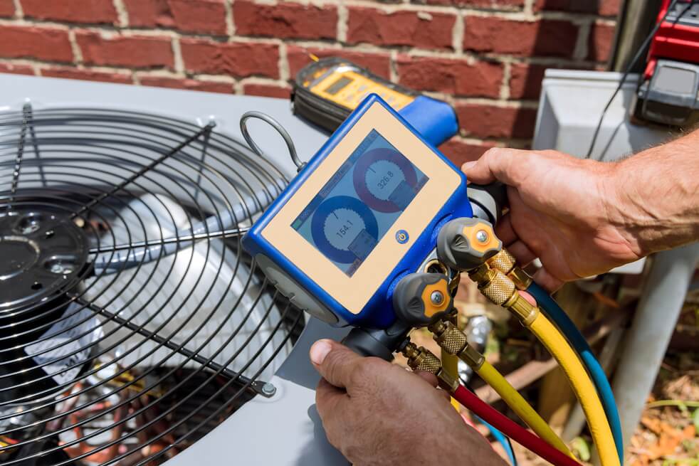 hvac technician checking ac unit