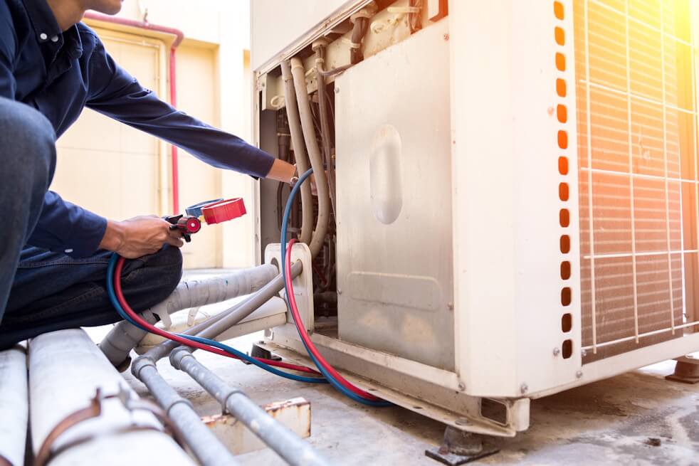 hvac technician checking home ac unit