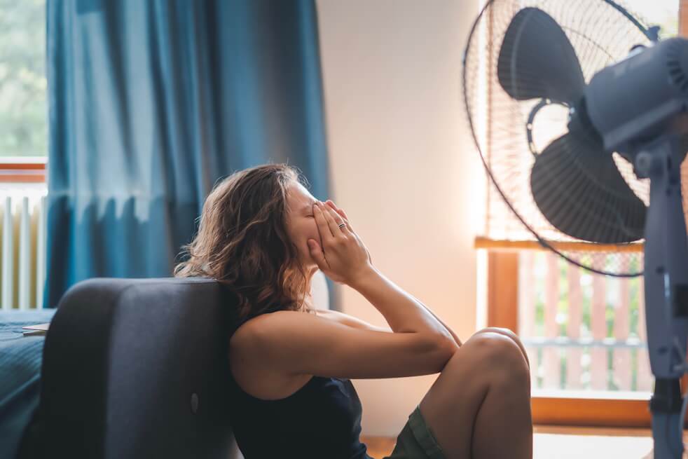 woman hot in house with broken ac