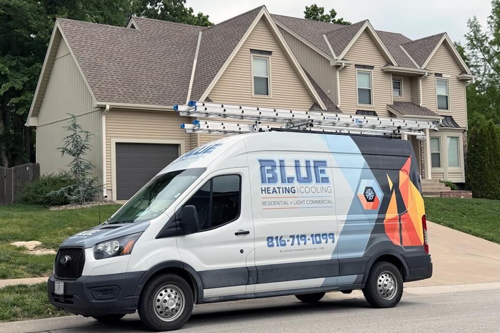 blue heating and cooling van in front of home
